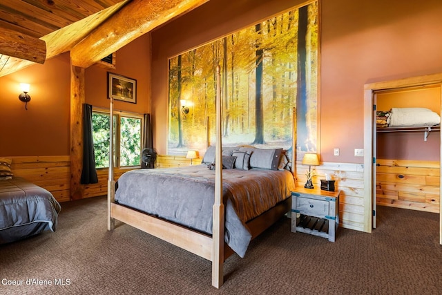 1050 Greenview Ln, Moscow, ID 83843 - bedroom featuring carpet floors, a wainscoted wall, beamed ceiling, wooden walls, and wooden ceiling