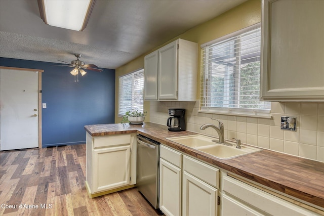 4413 W Pleasant Ln, Post Falls, ID 83854 - kitchen featuring dishwasher, a sink, a peninsula, ceiling fan, and backsplash