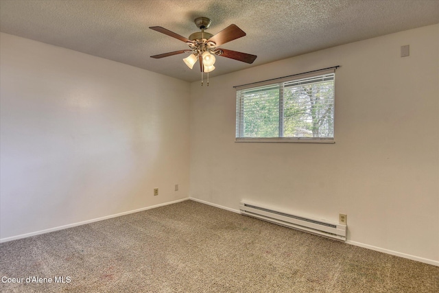 4413 W Pleasant Ln, Post Falls, ID 83854 - spare room featuring baseboard heating, dark colored carpet, a ceiling fan, baseboards, and a textured ceiling
