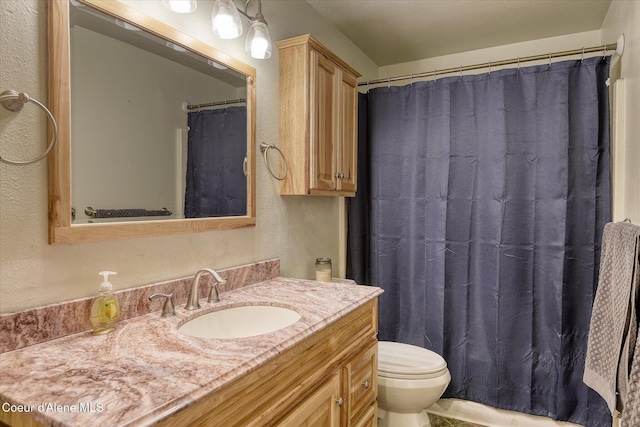 4413 W Pleasant Ln, Post Falls, ID 83854 - bathroom featuring a textured wall, vanity, toilet, and a shower with curtain