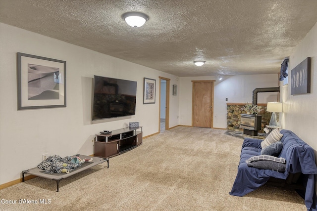 4413 W Pleasant Ln, Post Falls, ID 83854 - living area featuring a wood stove, carpet, baseboards, and a textured ceiling