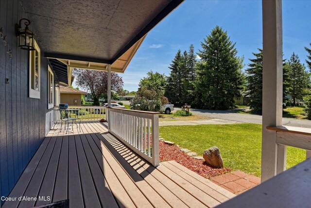 4413 W Pleasant Ln, Post Falls, ID 83854 - wooden porch featuring a lawn
