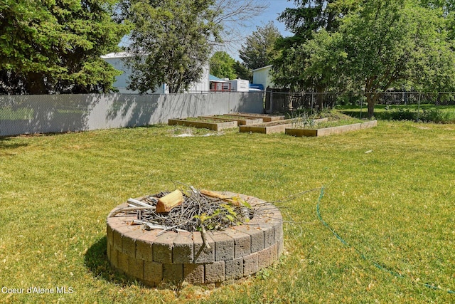 4413 W Pleasant Ln, Post Falls, ID 83854 - view of yard featuring a vegetable garden and an outdoor fire pit