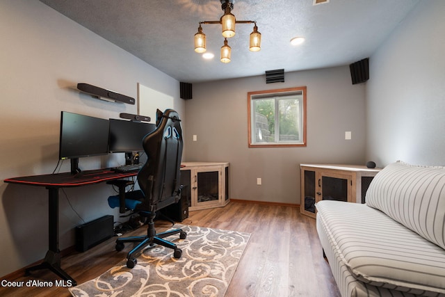 11624 N W Newman Lake Dr, Newman Lake, WA 99025 - home office with wood finished floors, baseboards, and a textured ceiling