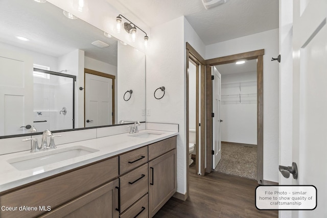 LT6BLK1 E Valley St, Oldtown, ID 83822 - bathroom featuring wood finished floors, a stall shower, toilet, double vanity, and recessed lighting