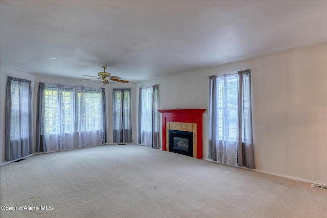 3168 N 9th St, Coeur Dalene, ID 83815 - unfurnished living room featuring carpet, plenty of natural light, and a tile fireplace