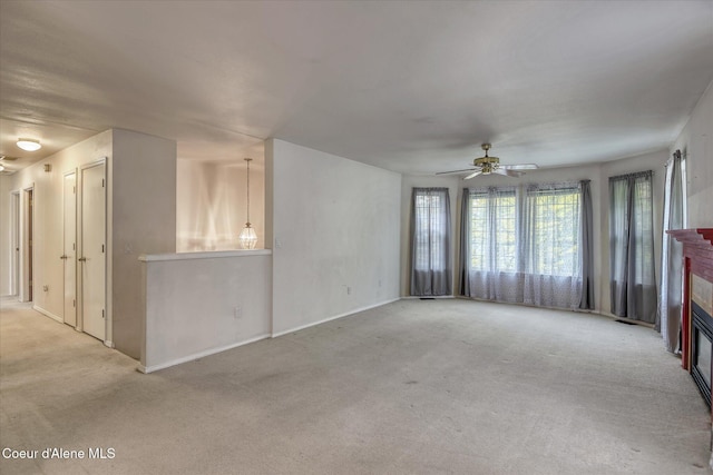 3168 N 9th St, Coeur Dalene, ID 83815 - carpeted empty room with a glass covered fireplace, ceiling fan, and baseboards