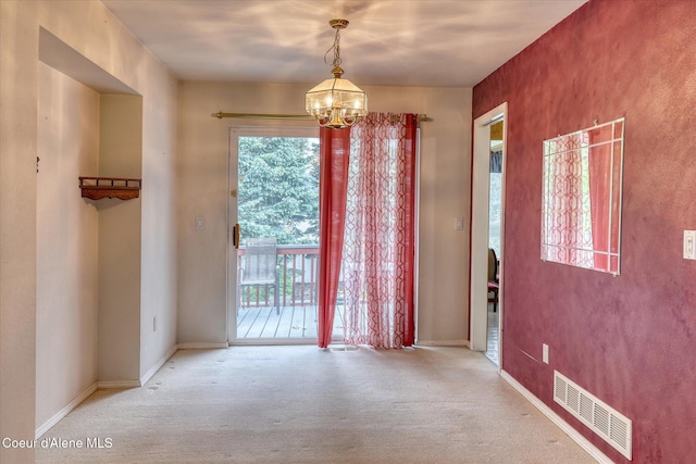 3168 N 9th St, Coeur Dalene, ID 83815 - empty room featuring a chandelier, carpet flooring, and baseboards