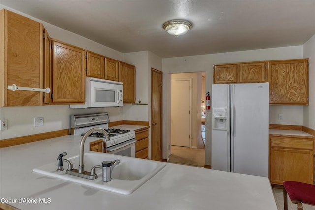 3168 N 9th St, Coeur Dalene, ID 83815 - kitchen featuring white appliances, light countertops, brown cabinets, and a sink
