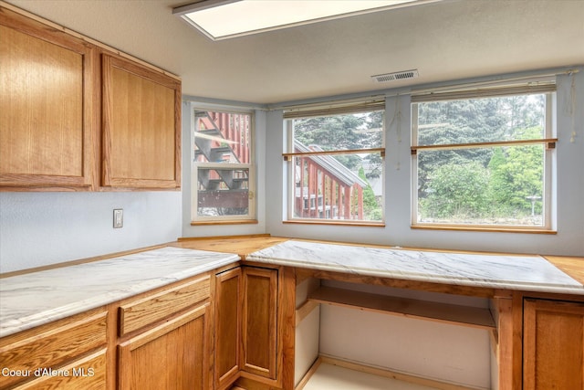 3168 N 9th St, Coeur Dalene, ID 83815 - kitchen with brown cabinets, light stone countertops, and an office area