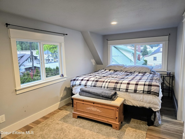 117 River St, Wallace, ID 83873 - bedroom with multiple windows, baseboards, light wood-type flooring, and recessed lighting