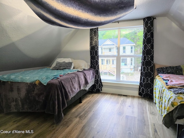 117 River St, Wallace, ID 83873 - bedroom featuring wood finished floors and lofted ceiling