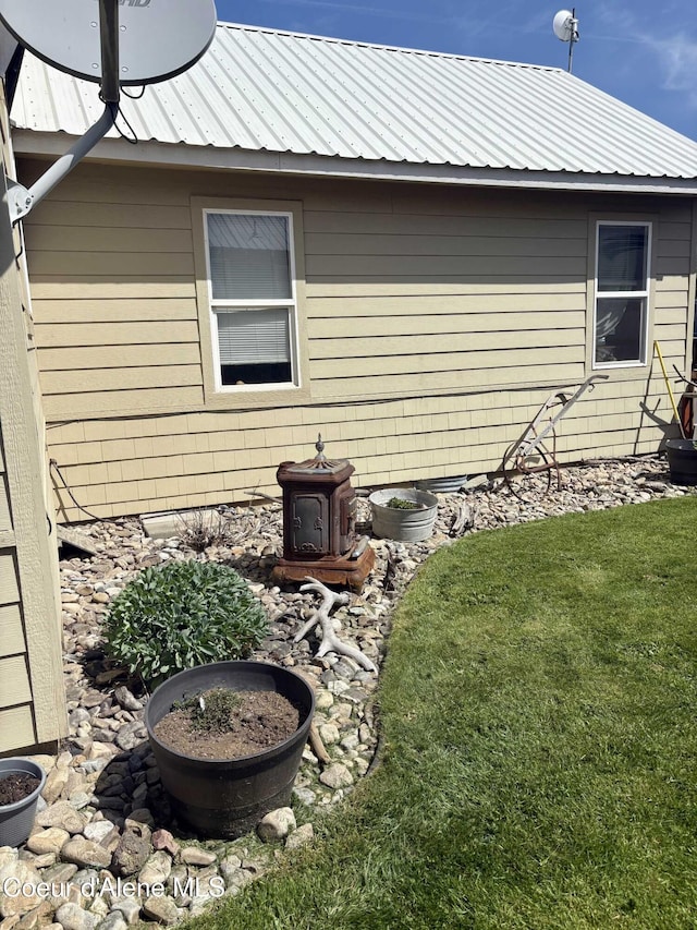 235 S 5th St, Saint Maries, ID 83861 - view of home's exterior featuring metal roof and a yard