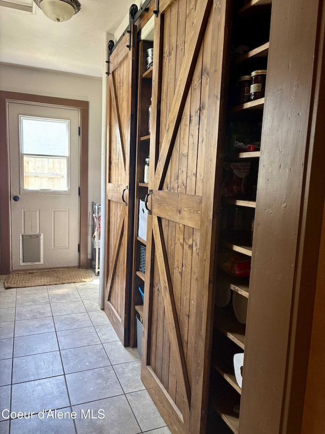 235 S 5th St, Saint Maries, ID 83861 - interior space with a barn door and light tile patterned flooring