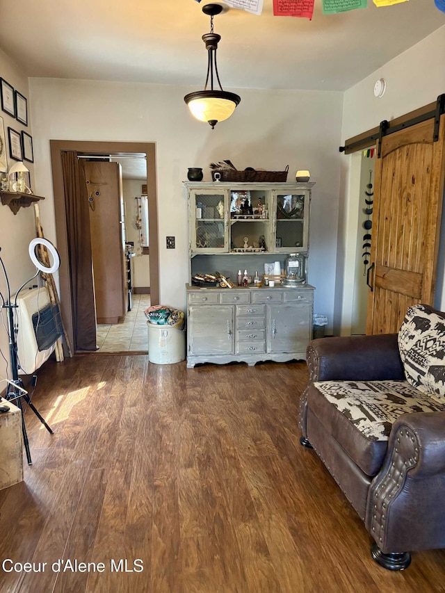 235 S 5th St, Saint Maries, ID 83861 - living room with wood finished floors and a barn door