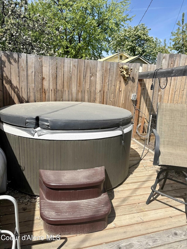 235 S 5th St, Saint Maries, ID 83861 - wooden terrace featuring a hot tub and fence
