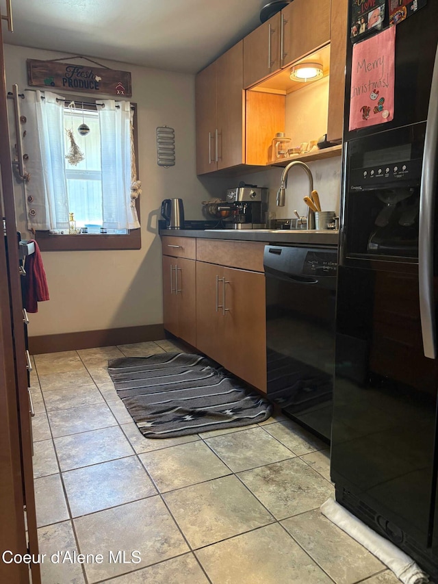 235 S 5th St, Saint Maries, ID 83861 - kitchen featuring black appliances, light tile patterned flooring, dark countertops, and a sink