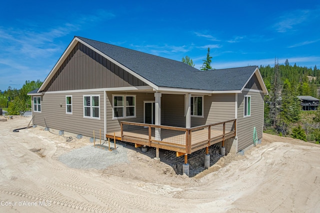204 Silver Saddle Ct, Pinehurst, ID 83850 - rear view of house featuring a wooden deck, board and batten siding, and roof with shingles