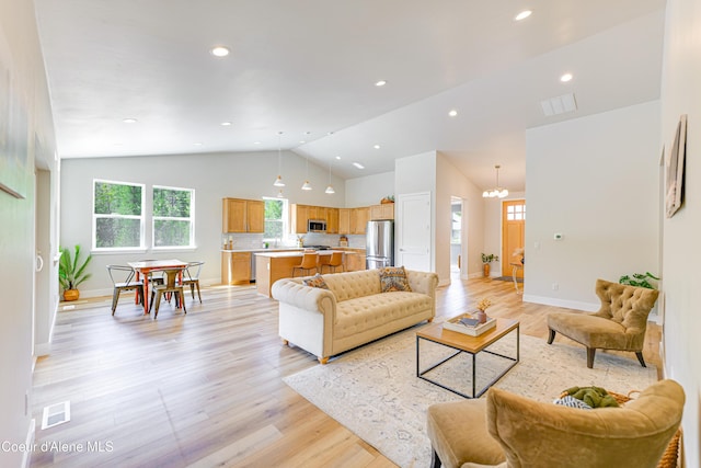 204 Silver Saddle Ct, Pinehurst, ID 83850 - living room with vaulted ceiling, light wood finished floors, a chandelier, baseboards, and recessed lighting