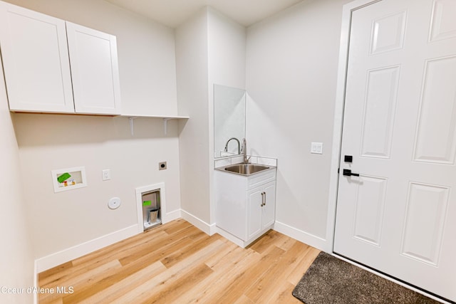 204 Silver Saddle Ct, Pinehurst, ID 83850 - laundry room featuring electric dryer hookup, washer hookup, light wood-style floors, baseboards, and cabinet space