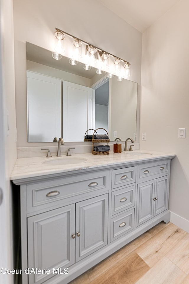 204 Silver Saddle Ct, Pinehurst, ID 83850 - full bath featuring double vanity, wood finished floors, and baseboards
