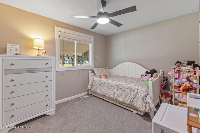carpeted bedroom with ceiling fan and baseboards