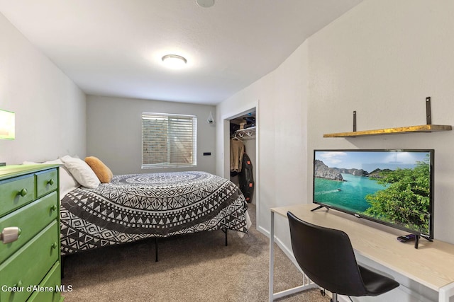 carpeted bedroom with a desk and a closet