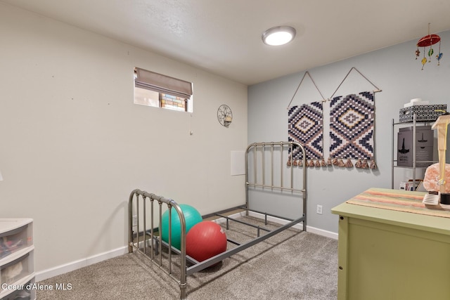 workout room featuring carpet floors and baseboards