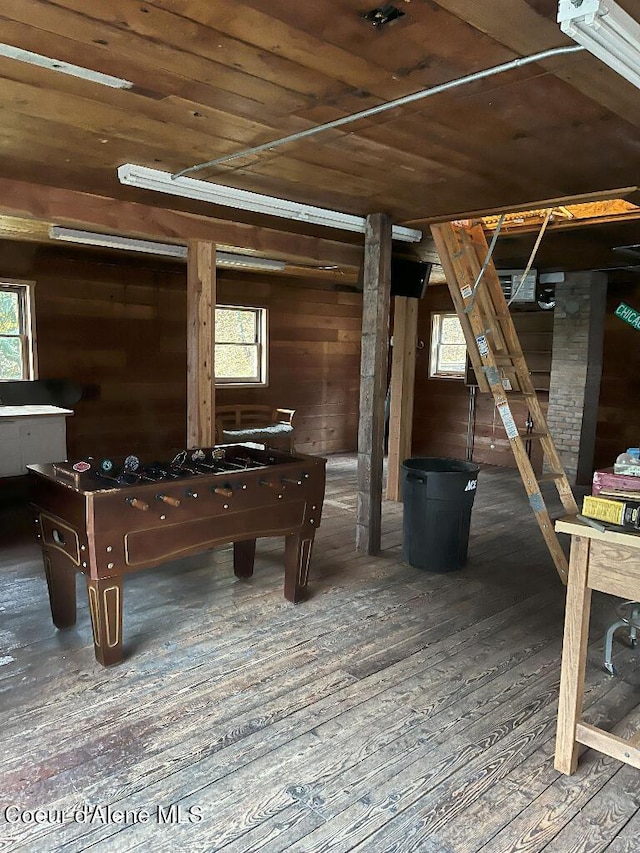 game room with wooden ceiling, hardwood / wood-style flooring, plenty of natural light, and wood walls