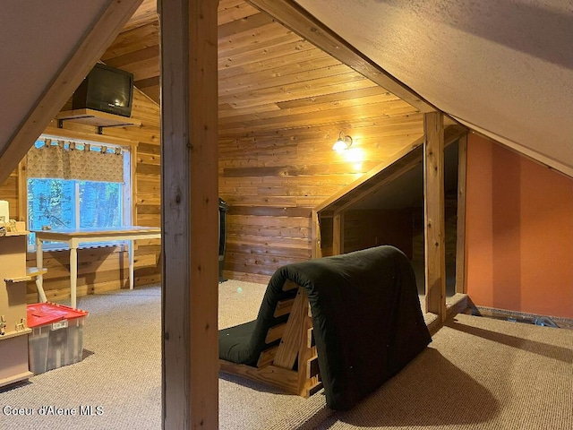 additional living space featuring carpet floors, vaulted ceiling, and wood walls