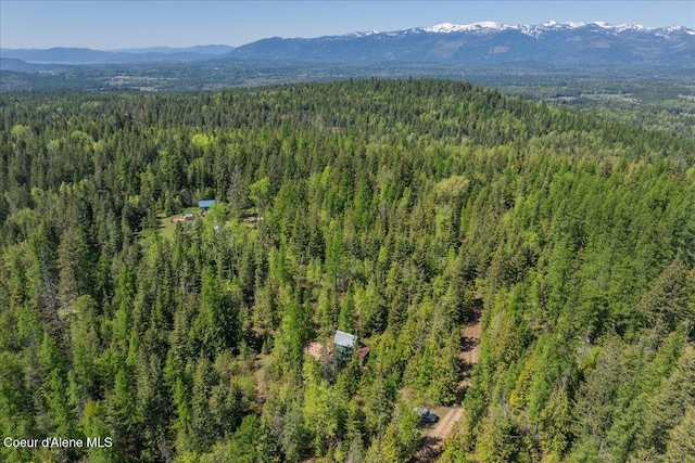 1438 Rolling Thunder Ridge Rd, Sandpoint, ID 83864 - drone / aerial view of a heavily wooded area and a mountainous background