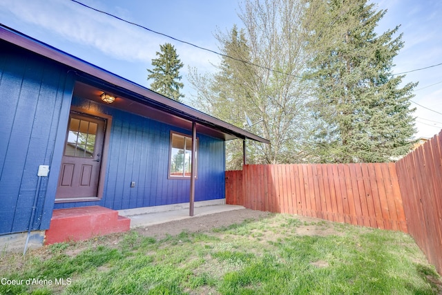 view of exterior entry featuring fence