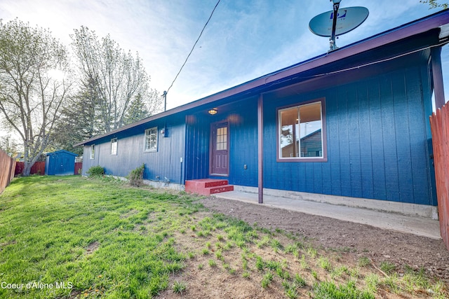 view of front of home with a storage shed and an outbuilding
