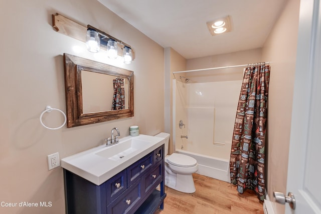full bathroom with wood finished floors, vanity, toilet, and shower / bath combo