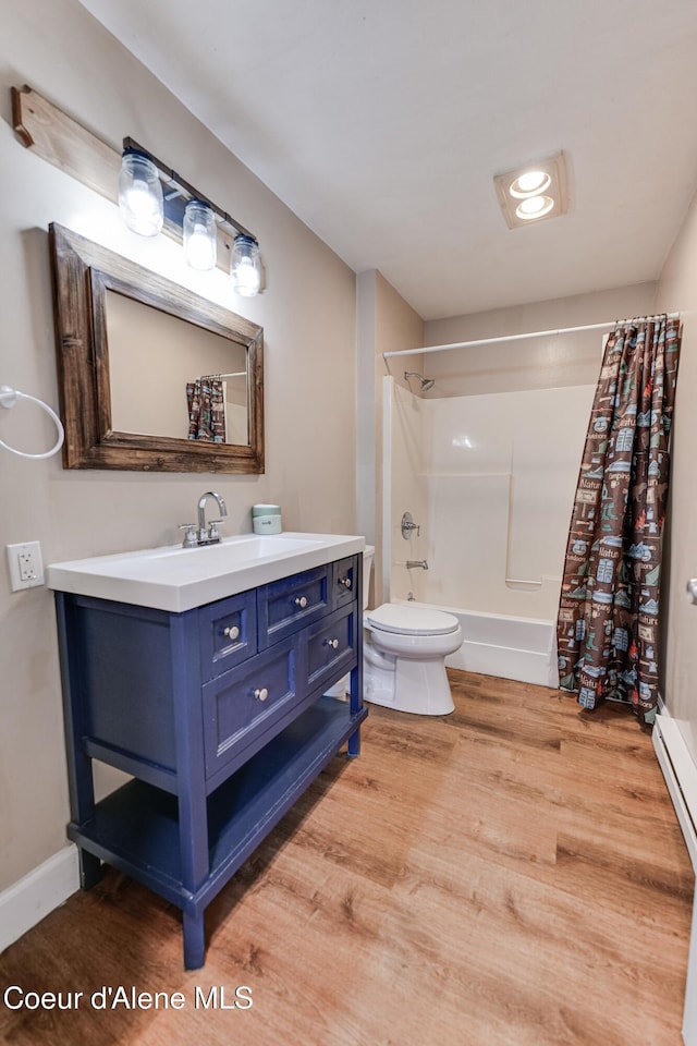 full bathroom with wood finished floors, shower / bath combination with curtain, toilet, baseboard heating, and vanity