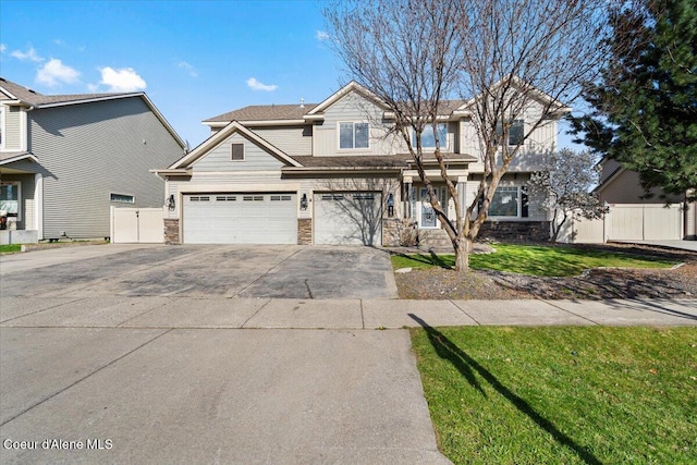 8747 Salmonberry Lp, Hayden, ID 83835 - view of front facade featuring stone siding, concrete driveway, and an attached garage