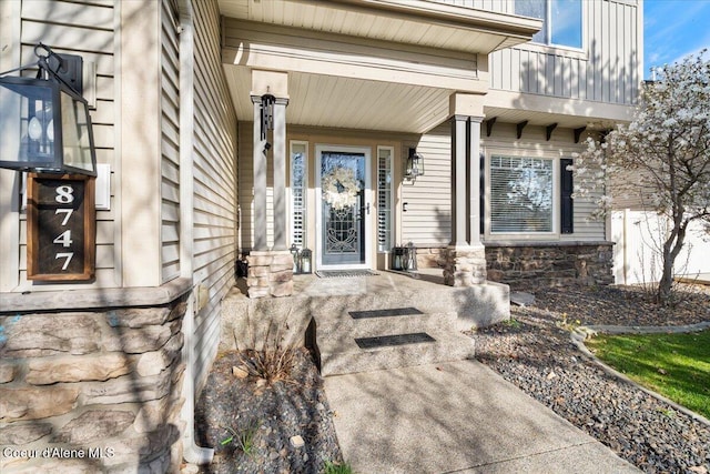 8747 Salmonberry Lp, Hayden, ID 83835 - entrance to property featuring stone siding and a porch