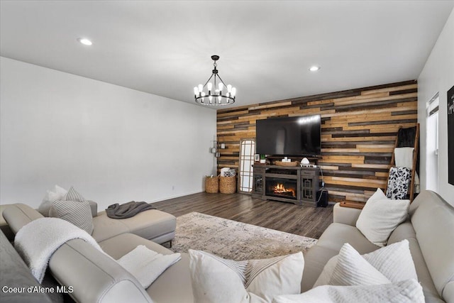 8747 Salmonberry Lp, Hayden, ID 83835 - living area with wood walls, an accent wall, a chandelier, recessed lighting, and baseboards