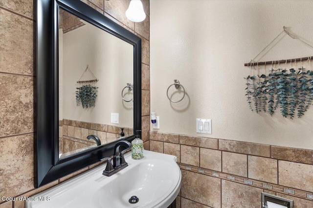 8747 Salmonberry Lp, Hayden, ID 83835 - bathroom with tile walls, a sink, and wainscoting