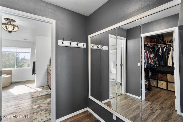 8747 Salmonberry Lp, Hayden, ID 83835 - interior space with wood finished floors, a textured wall, and baseboards