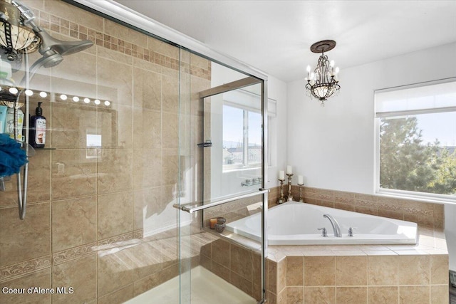8747 Salmonberry Lp, Hayden, ID 83835 - full bathroom with a bath, healthy amount of natural light, a shower stall, and a chandelier