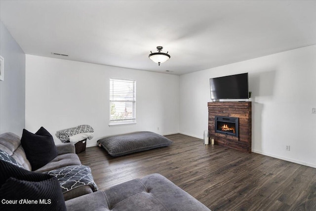 8747 Salmonberry Lp, Hayden, ID 83835 - living room with wood finished floors, a fireplace, and baseboards