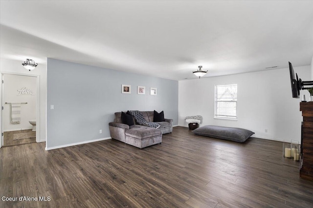 8747 Salmonberry Lp, Hayden, ID 83835 - living room with wood finished floors, baseboards, and a fireplace