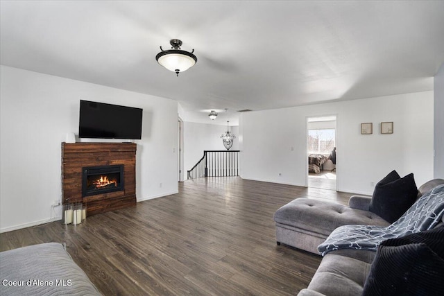 8747 Salmonberry Lp, Hayden, ID 83835 - living room featuring wood finished floors, a lit fireplace, and baseboards
