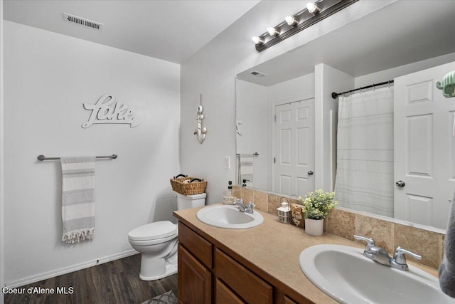8747 Salmonberry Lp, Hayden, ID 83835 - full bathroom with toilet, wood finished floors, and double vanity