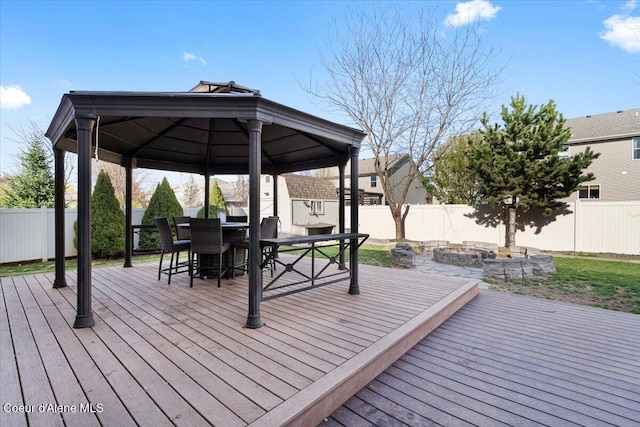 8747 Salmonberry Lp, Hayden, ID 83835 - wooden deck with a gazebo, an outdoor fire pit, and a fenced backyard