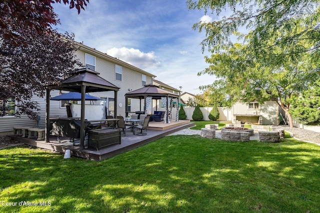 8747 Salmonberry Lp, Hayden, ID 83835 - rear view of property featuring a gazebo, a deck, and an outdoor living space with a fire pit