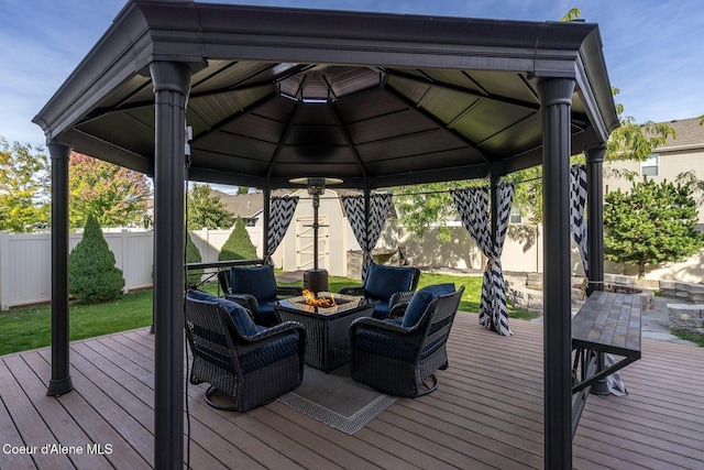 8747 Salmonberry Lp, Hayden, ID 83835 - deck with a gazebo, a fire pit, and a fenced backyard