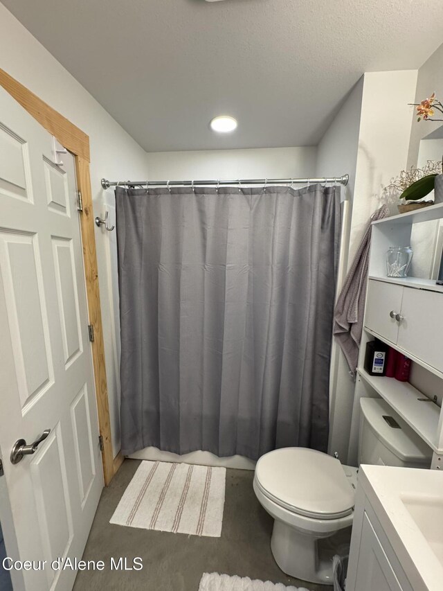 1203 Chestnut St, Sandpoint, ID 83864 - bathroom with toilet, vanity, a shower with shower curtain, and a textured ceiling
