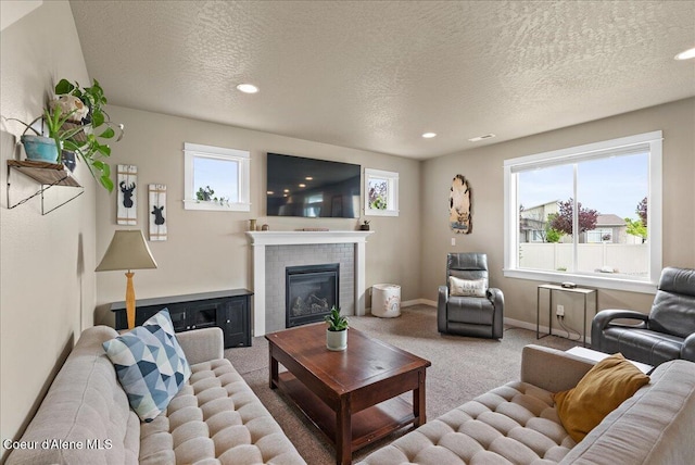 3402 N Croghan Dr, Post Falls, ID 83854 - carpeted living area featuring a textured ceiling, a tile fireplace, recessed lighting, and baseboards